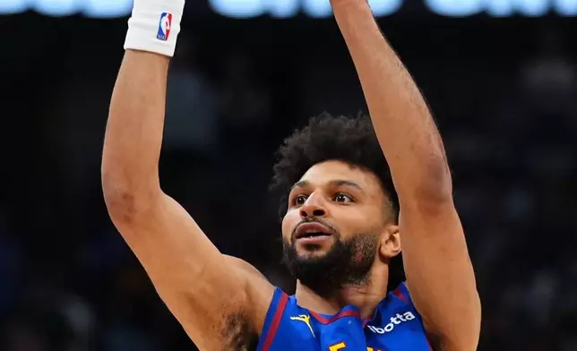 Denver Nuggets guard Jamal Murray prepares to shoot a 3-point basket against the Minnesota Timberwolves during the first half in Game 2 of a first-round NBA playoffs basketball series Monday, April 20, 2026, in Denver. (AP Photo/Jack Dempsey)
