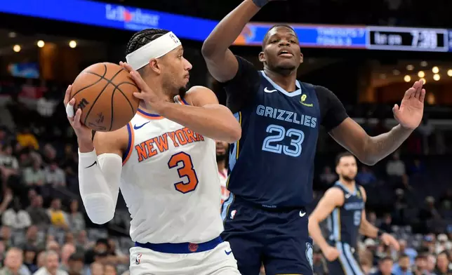 New York Knicks guard Josh Hart (3) handles the ball against Memphis Grizzlies forward Cedric Coward (23) in the first half of an NBA basketball game Wednesday, April 1, 2026, in Memphis, Tenn. (AP Photo/Brandon Dill)