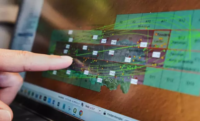 An archaeologist points to a computer screen, showing a map of the wreck of Danish flagship "Dannebroge" that sank during the Battle of Copenhagen in 1801. in Copenhagen, Denmark, Tuesday, March 31, 2026. (AP Photo/James Brooks)