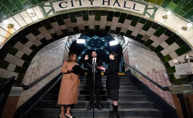 FILE - New York Attorney General Letitia James, left, administers the oath of office to mayor-elect Zohran Mamdani, center, as his wife Rama Duwaji looks on, Jan. 1, 2026, in New York. (AP Photo/Yuki Iwamura, File)