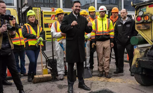 FILE - New York Mayor Zohran Mamdani and Department of Transportation workers fix a bump near the Williamsburg Bridge on Jan. 6, 2026, in New York. (AP Photo/Yuki Iwamura, File)