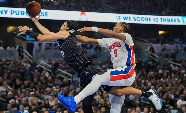 Detroit Pistons guard Ausar Thompson (9) fouls Orlando Magic guard Anthony Black (0) as he goes up for a shot during the second half in Game 3 of a first-round NBA basketball playoff series, Saturday, April 25, 2026, in Orlando, Fla. (AP Photo/John Raoux)