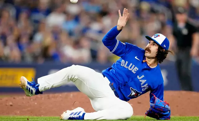 Toronto Blue Jays pitcher Dylan Cease misses the ground ball hit by Boston Red Sox's Roman Anthony as he tumbles off the mound, allowing a run to score, during fifth-inning baseball game action in Toronto, Monday, April 27, 2026. (Frank Gunn/The Canadian Press via AP)