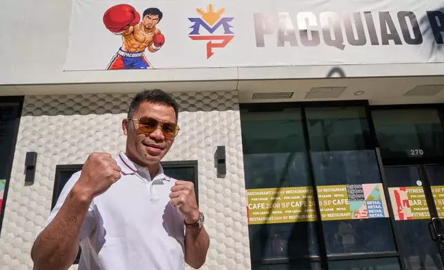 Boxer Manny Pacquiao pauses for a picture outside his "Pacquiao Prime Boxing," his newly acquired gym in Hollywood, on Monday, April 6, 2026. The facility was formerly owned by rival Floyd Mayweather Jr. (AP Photo/Damian Dovarganes)