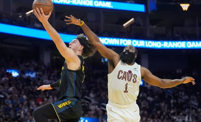 Golden State Warriors guard Brandin Podziemski, left, shoots against Cleveland Cavaliers guard James Harden during the first half of an NBA basketball game in San Francisco, Thursday, April 2, 2026. (AP Photo/Jeff Chiu)