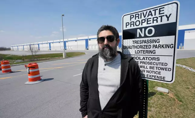 Activist Patrick Dattilio stands in front of a proposed ICE detention center in Williamsport, Md., Thursday, March 26, 2026. (AP Photo/Steve Helber)