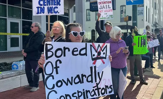 Protesters rally against a planned immigration detention facility outside a Washington County Commission meeting in Hagerstown, Md., Tuesday, March 31, 2026. (AP Photo/Nathan Ellgren)