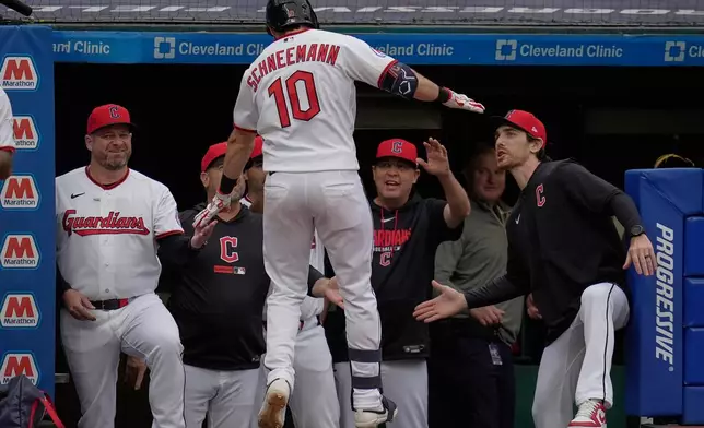 Cleveland Guardians' Daniel Schneemann (10) is congratulated as he returns to the dugout after hitting a two-run home run in the fifth inning of a baseball game against the Tampa Bay Rays in Cleveland, Monday, April 27, 2026. (AP Photo/Sue Ogrocki)