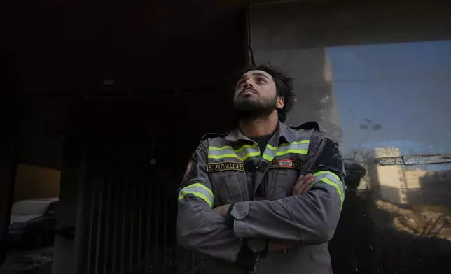 A Lebanese civil defense worker looks upward near the site of a building destroyed in an Israeli airstrike a day earlier in central Beirut, Lebanon, Thursday, April 9, 2026. (AP Photo/Hassan Ammar)