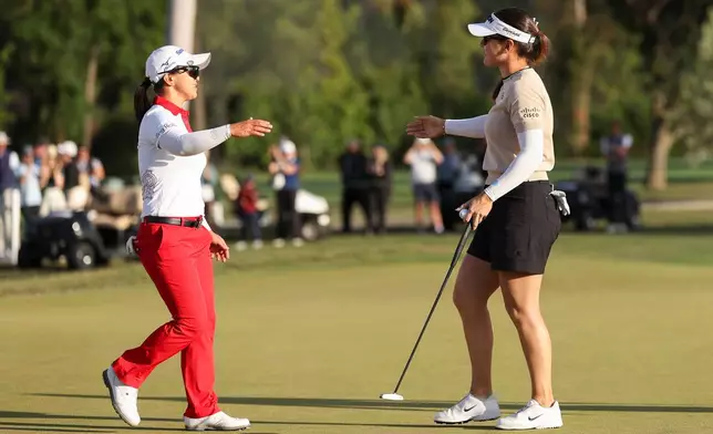 Sei Young Kim, left, and Hannah Green, right, embrace after Green wins the LPGA JM Eagle LA Championship golf tournament at El Caballero Country Club Sunday, April 19, 2026, in Los Angeles. (AP Photo/Jessie Alcheh)