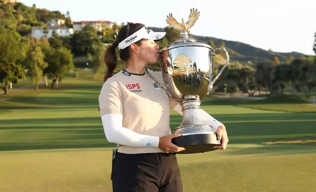 Hannah Green poses with the trophy after winning the LPGA JM Eagle LA Championship golf tournament at El Caballero Country Club Sunday, April 19, 2026, in Los Angeles. (AP Photo/Jessie Alcheh)
