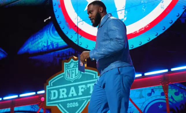 Tennessee Titans' Jeffery Simmons walks across the stage before announcing a pick by the Tennessee Titans during the second round of the NFL football draft, Friday, April 24, 2026, in Pittsburgh. (AP Photo/Gene J. Puskar)