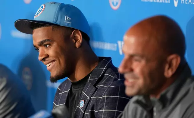 Tennessee Titans first round draft pick Keldric Faulk, left, responds to questions during a news conference at the NFL football team's training facility Friday, April 24, 2026, in Nashville, Tenn. (AP Photo/George Walker IV)