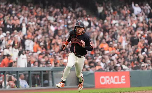 San Francisco Giants' Jung Hoo Lee runs home to score against the Miami Marlins during the sixth inning of a baseball game Saturday, April 25, 2026, in San Francisco. (AP Photo/Jeff Chiu)