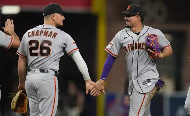 San Francisco Giants shortstop Willy Adames, right, celebrates with teammate third baseman Matt Chapman (26) after the Giants defeated the San Diego Padres 9-3 in a baseball game Tuesday, March 31, 2026, in San Diego. (AP Photo/Gregory Bull)