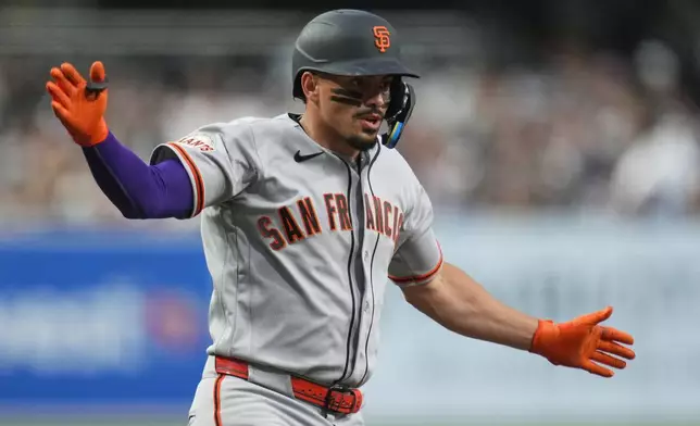 San Francisco Giants' Willy Adames celebrates his home run during the first inning of a baseball game against the San Diego Padres Tuesday, March 31, 2026, in San Diego. (AP Photo/Gregory Bull)