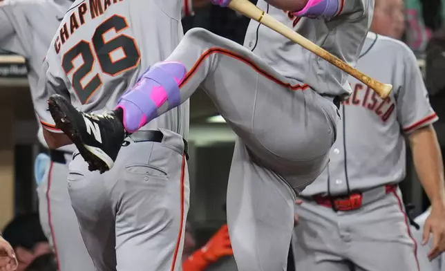 San Francisco Giants' Matt Chapman (26) celebrates his home run with teammate Harrison Bader during the third inning of a baseball game against the San Diego Padres Tuesday, March 31, 2026, in San Diego. (AP Photo/Gregory Bull)