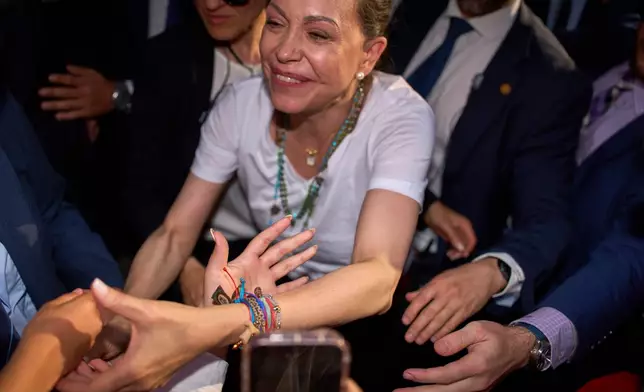 Venezuela's opposition leader Maria Corina Machado greets the crowd at Madrid's Puerta del Sol, in Madrid, Spain, Saturday, April 18, 2026. (AP Photo/Manu Fernandez)