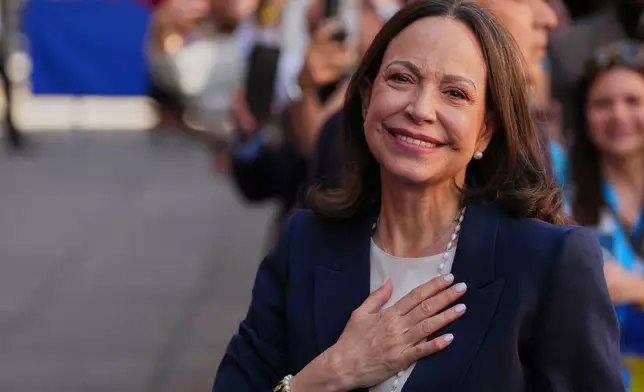 Venezuelan opposition leader Maria Corina Machado reacts before receiving the Golden Key of the City of Madrid from Madrid Mayor Jose Luis Martinez-Almeida in Madrid, Spain, Friday, April 17, 2026. (AP Photo/Manu Fernandez)