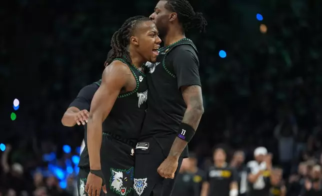 Minnesota Timberwolves guard Ayo Dosunmu, left, celebrates with center Naz Reid, right, after making a 3-point basket during the second half of Game 4 of a first-round NBA basketball playoff series against the Denver Nuggets, Saturday, April 25, 2026, in Minneapolis. (AP Photo/Abbie Parr)