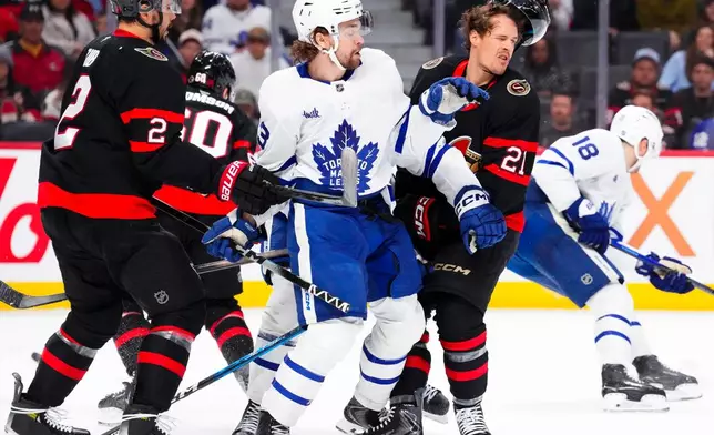 Toronto Maple Leafs' Matias MacCelli (63) collides with Ottawa Senators' Nick Cousins (21) during the first period of an NHL hockey game in Ottawa, Ontario, Wednesday, April 15, 2026. (Sean Kilpatrick/The Canadian Press via AP)