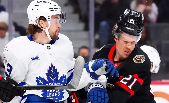 Toronto Maple Leafs' Matias MacCelli (63) collides with Ottawa Senators' Nick Cousins (21) during the first period of an NHL hockey game in Ottawa, Ontario, on Wednesday, April 15, 2026. (Sean Kilpatrick/The Canadian Press via AP)