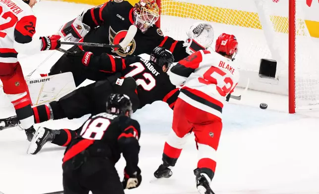 Carolina Hurricanes' Jackson Blake (53) scores on Ottawa Senators goaltender Linus Ullmark (35) as Senator's Thomas Chabot (72) defends during the second period of an NHL hockey playoff game in Ottawa, Ontario, Thursday, April 23, 2026. (Sean Kilpatrick/The Canadian Press via AP)