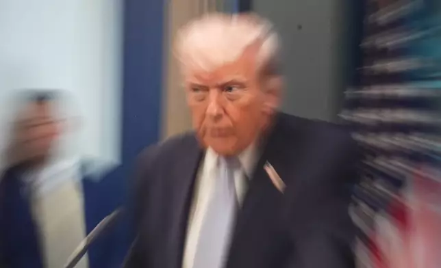 A zoom lens and slow shutter speed technique shows President Donald Trump speaking with reporters in the James Brady Press Briefing Room at the White House, Monday, April 6, 2026, in Washington.(AP Photo/Alex Brandon)
