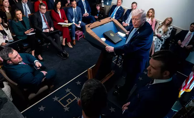 President Donald Trump, accompanied by Defense Secretary Pete Hegseth and Chairman of the Joint Chiefs of Staff Gen. Dan Caine, speaks with reporters in the James Brady Press Briefing Room at the White House, Monday, April 6, 2026, in Washington. (AP Photo/Julia Demaree Nikhinson)