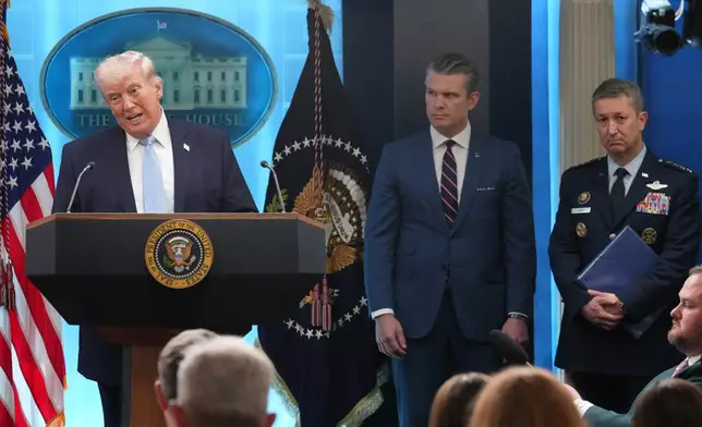 President Donald Trump speaks with reporters during a news conference in the James Brady Press Briefing Room at the White House, Monday, April 6, 2026, in Washington, as Defense Secretary Pete Hegseth and Chairman of the Joint Chiefs of Staff Gen. Dan Caine listen. (AP Photo/Mark Schiefelbein)