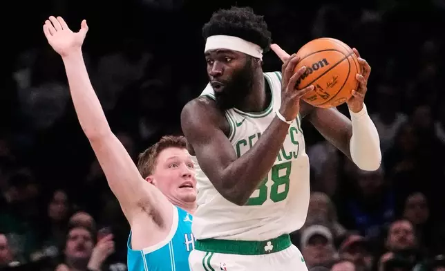 Boston Celtics center Neemias Queta (88) prepares to drive on Charlotte Hornets guard Kon Knueppel (7) during the first half of a NBA basketball game, Tuesday, April 7, 2026, in Boston. (AP Photo/Charles Krupa)