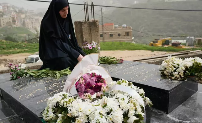 Malak Meslmani, the mother of Jawad Younes, 11, who was killed on March 27, 2026 in an Israeli airstrike, visits her son's grave in Saksakieh village, south Lebanon, Friday, April 3, 2026. (AP Photo/Hussein Malla)