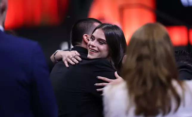 UCLA guard Gabriela Jaquez hugs family after being selected fifth overall by the Chicago Sky in the first round of the WNBA basketball draft Monday, April 13, 2026, in New York. (AP Photo/Pamela Smith)