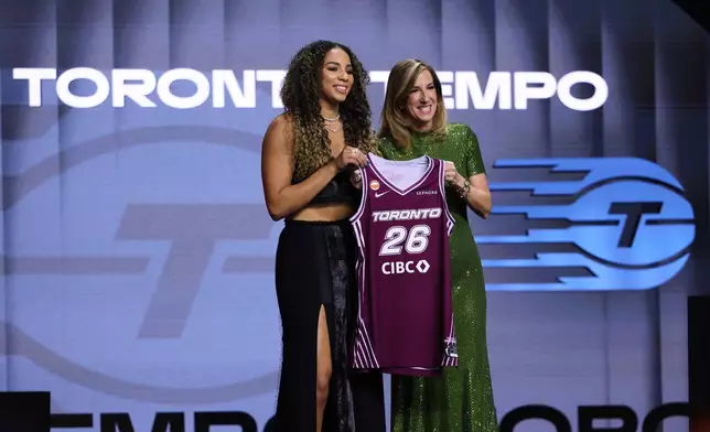 UCLA guard Kiki Rice poses with WNBA commissioner Cathy Engelbert after being selected sixth overall by the Toronto Tempo in the first round of the WNBA basketball draft Monday, April 13, 2026, in New York. (AP Photo/Pamela Smith)