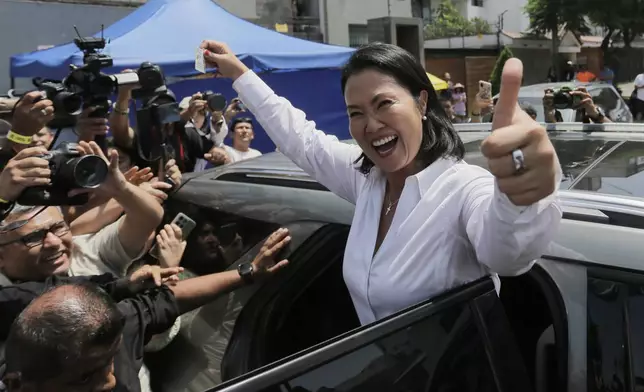 Keiko Fujimori, presidential candidate of the Popular Force party, departs a polling station after voting during general elections in Lima, Peru, Sunday, April 12, 2026. (AP Photo/Gerardo Marin)