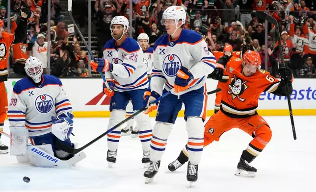Anaheim Ducks center Mikael Granlund, right, celebrates his goal as Edmonton Oilers goaltender Connor Ingram, left, reacts during the first period of Game 3 in the first round of the NHL hockey Stanley Cup playoffs Friday, April 24, 2026, in Anaheim, Calif. (AP Photo/Mark J. Terrill)