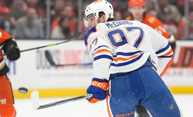 Edmonton Oilers center Connor McDavid watches as the puck flies in front of him during the first period of Game 3 in the first round of the NHL hockey Stanley Cup playoffs series against the Anaheim Ducks, Friday, April 24, 2026, in Anaheim, Calif. (AP Photo/Mark J. Terrill)