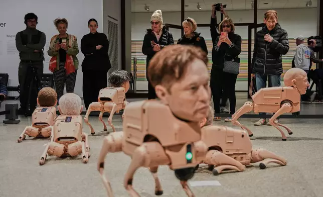 Robots in the likeness of Elon Musk, foreground, and Jeff Bezos, left, are displayed at the installation titled Regular Animals by artist Beeple, Mike Winkelmann, at the Neue Nationalgalerie museum in Berlin, Germany, Tuesday, April 28, 2026. (AP Photo/Markus Schreiber)