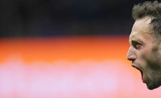 Inter Milan's Hakan Calhanoglu celebrates after scoring their second goal during the Italian Cup, second-leg soccer match between Inter Milan and Como, in Milan, Italy, Tuesday, April 21, 2026. (Spada/LaPresse via AP)
