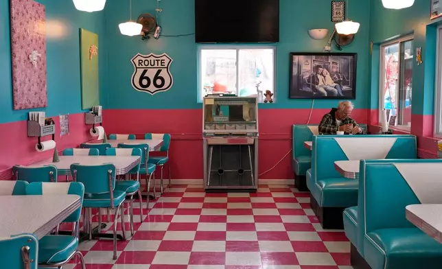 Everett Swett has lunch inside the Twistee Treat Diner, a 50s-style diner and ice cream shop along Historic Route 66 in Livingston, Ill., Thursday, Nov. 20, 2025. (AP Photo/Jeff Roberson)