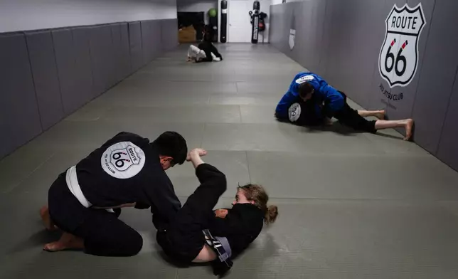 Alex Lara, left, and Rosie Diehl practice jiu-jitsu at Route 66 Jiu Jitsu Academy in Williams, Ariz., a town on the historic highway, Thursday, Nov. 20, 2025. (AP Photo/Jae C. Hong)