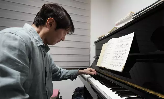 South Korean pianist Lee Hun demonstrates how to play the piano after an interview in Seoul, South Korea, Wednesday, April 8, 2026. (AP Photo/Lee Jin-man)
