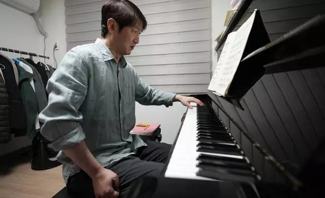 South Korean pianist Lee Hun demonstrates how to play the piano after an interview in Seoul, South Korea, Wednesday, April 8, 2026. (AP Photo/Lee Jin-man)