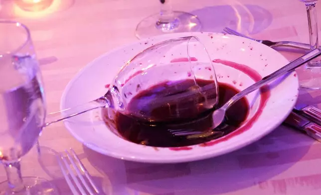 FILE - A tipped-over wine glass sits in a bowl on an abandoned table after gunfire erupted at the Washington Hilton during the White House Correspondents' Dinner in Washington, April 25, 2026. (AP Photo/Tom Brenner, File)