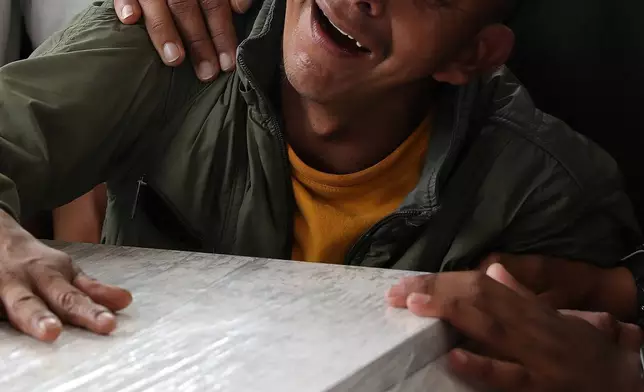 FILE - A relative mourns during a funeral for a family member who was killed in an attack on the Pan-American Highway that authorities blamed on dissident former FARC rebels, in Cajibio, Colombia, April 28, 2026. (AP Photo/Santiago Saldarriaga, File)