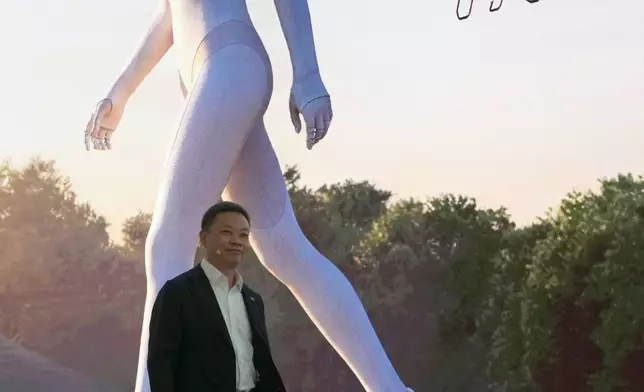 FILE - CEO of Xpeng He Xiaopeng arrives at his company's booth during the Auto China in Beijing, April 24, 2026. (AP Photo/Ng Han Guan, File)