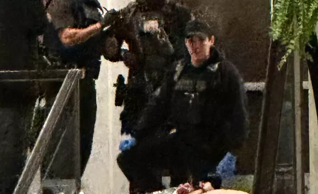 FILE - Members of law enforcement control shooting suspect Cole Tomas Allen during the White House Correspondents Dinner, in Washington, April 25, 2026. (AP Photo/Alex Brandon, File)