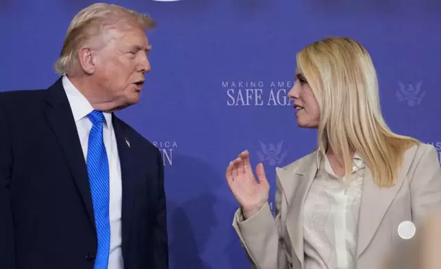 President Donald Trump speaks with Attorney General Pam Bondi during a roundtable discussion on public safety at a Tennessee Air National Guard Base, Monday, March 23, 2026, in Memphis, Tenn. (AP Photo/Mark Schiefelbein)