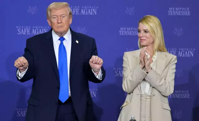President Donald Trump participates in a roundtable discussion on public safety at a Tennessee Air National Guard Base, Monday, March 23, 2026, in Memphis, Tenn., with Attorney General Pam Bondi, right. (AP Photo/Bruce Newman)