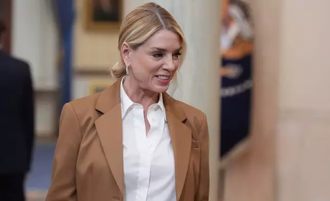 Attorney General Pam Bondi arrives before President Donald Trump speaks about the Iran war from the Cross Hall of the White House on Wednesday, April 1, 2026, in Washington. (AP Photo/Alex Brandon, Pool)